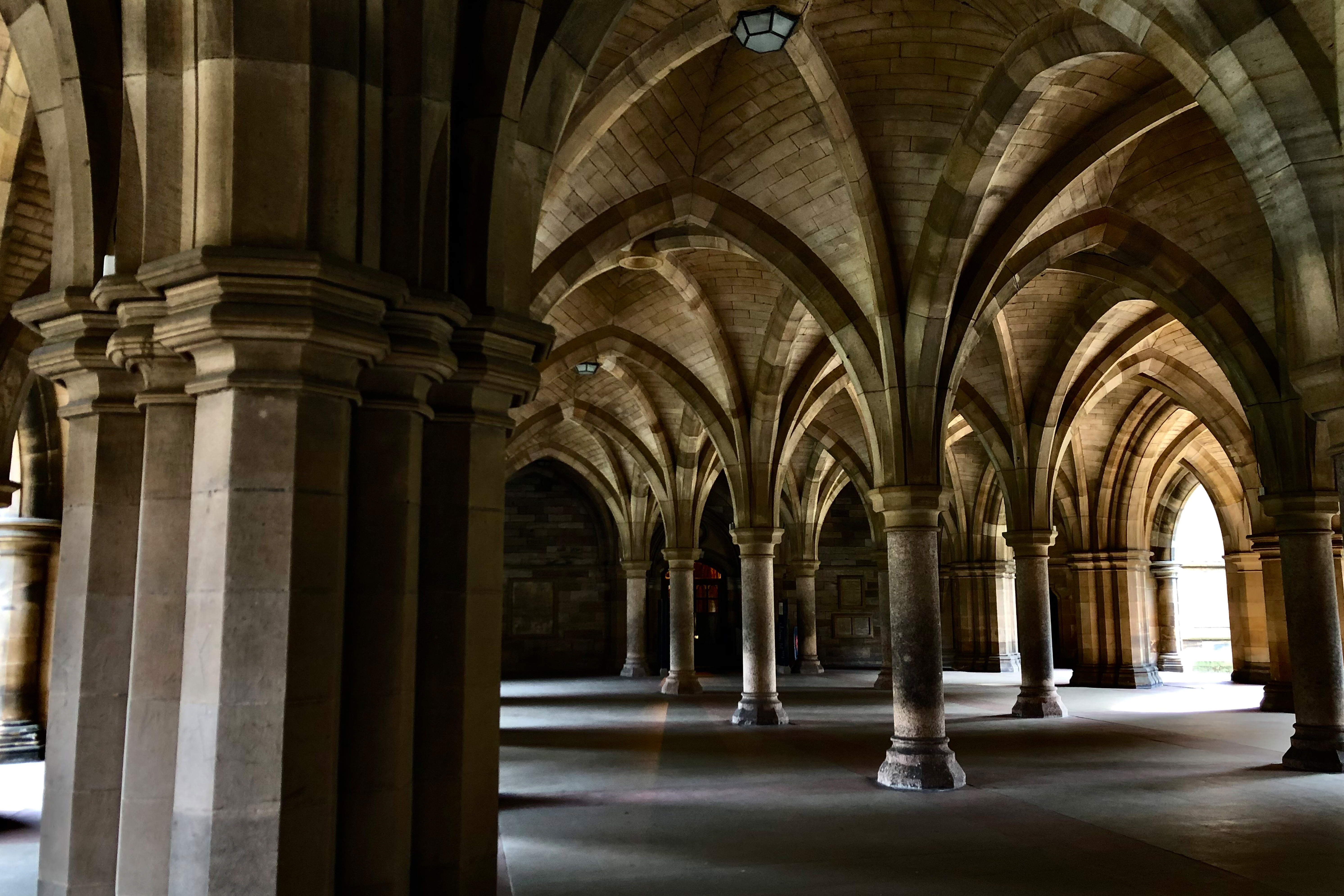 Photo of the inside of an old building in Scotland. Massive arches and pillars fill the room.