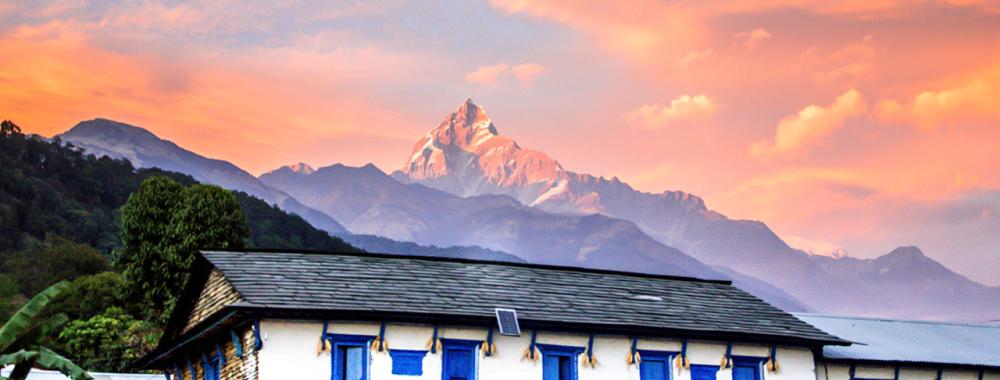 Teaser image of a building and mountain in Nepal - Click to learn more about this program