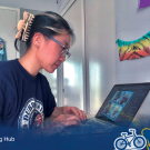 Photo of a student in front of her computer participating in global internship