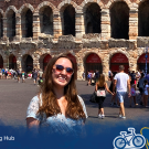 Photo of a student standing in front of the Verona Arena in Verona, Italy.