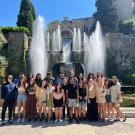 Students standing in front of a large fountain in Rome, Italy
