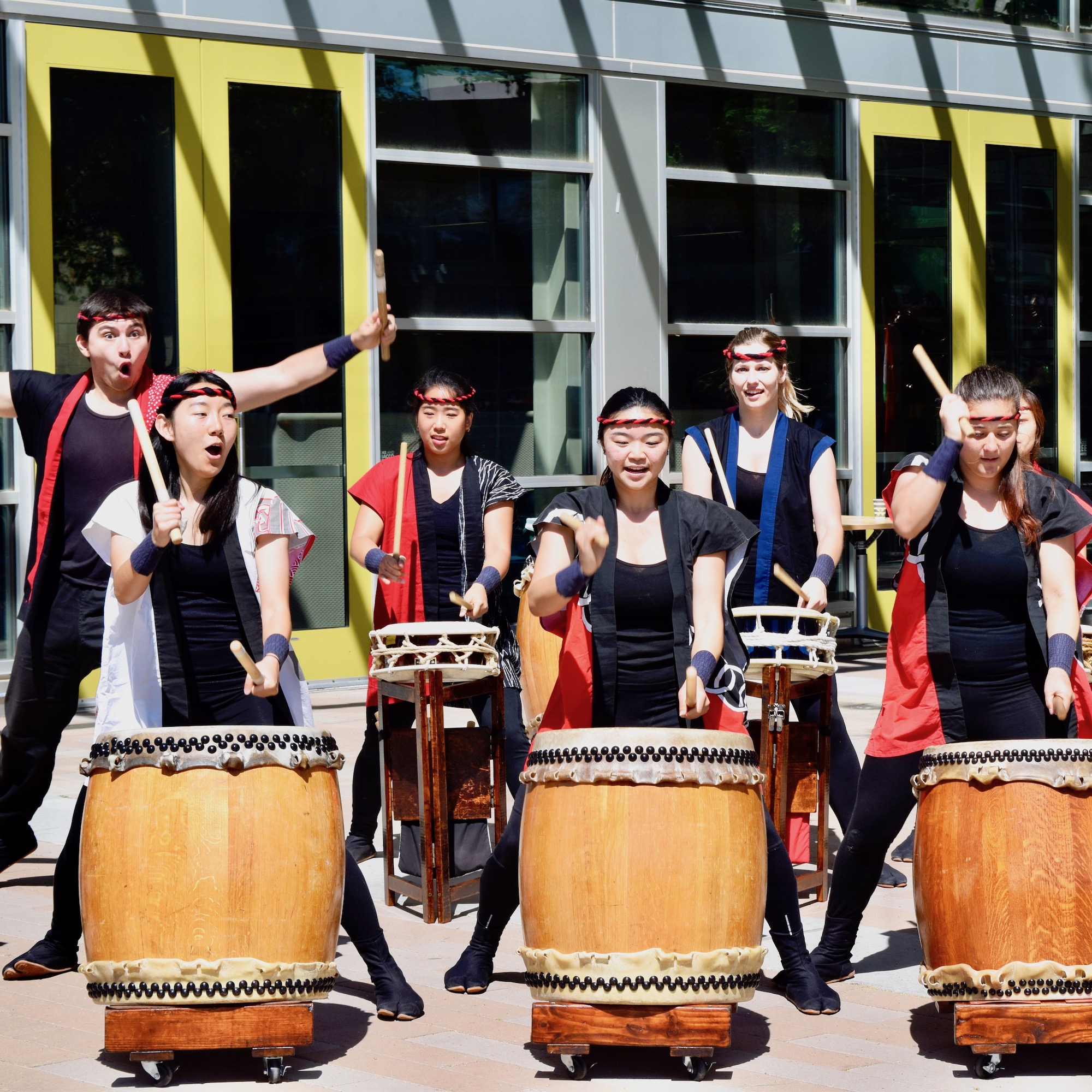 students drumming at event
